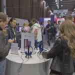 KIEV, UKRAINE - OCTOBER 11, 2015: People visit Apple, an American multinational technology company booth during CEE 2015, the largest electronics trade show of Ukraine in ExpoPlaza Exhibition Center.